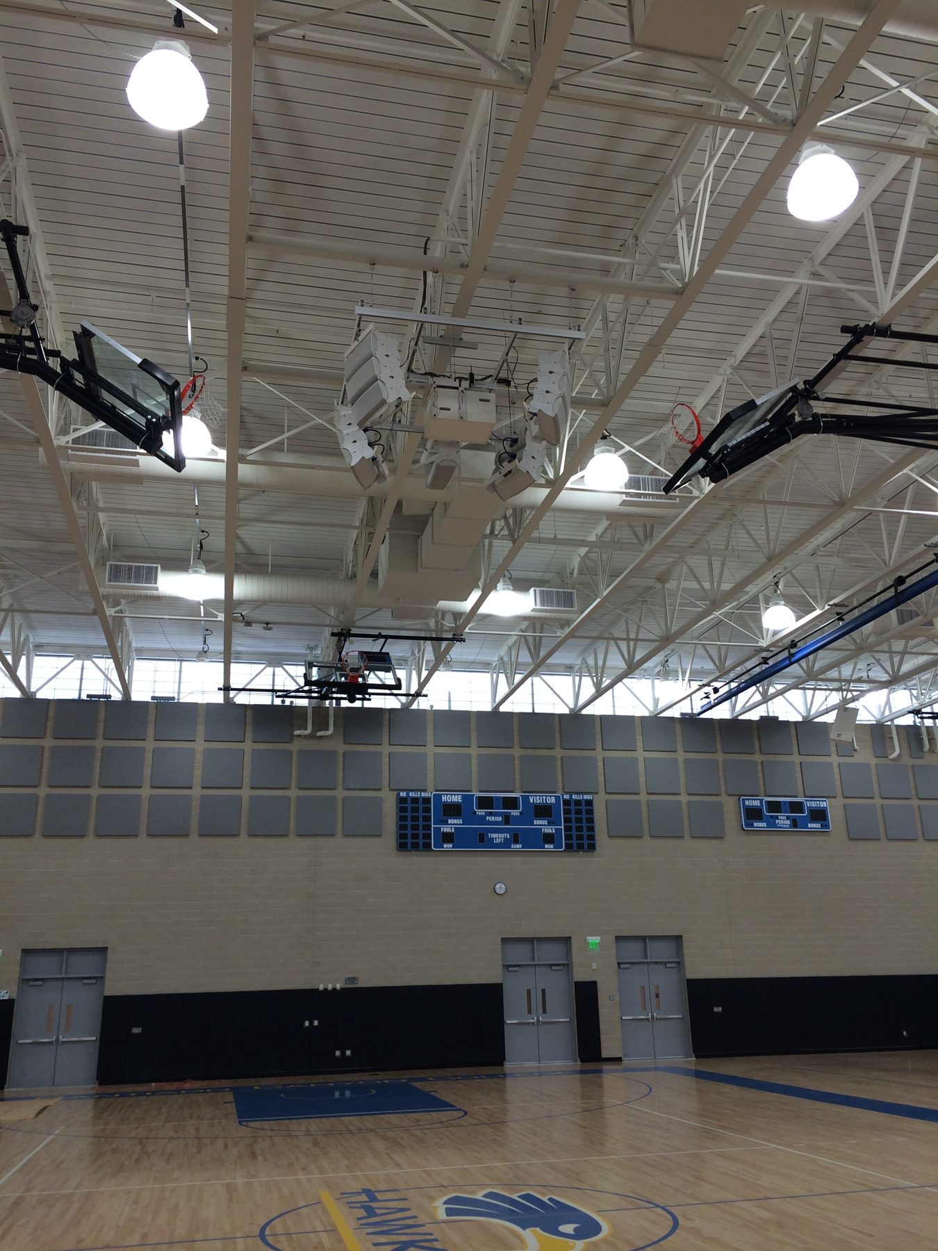 Gymnasium with distributed loudspeakers and scoreboard displays